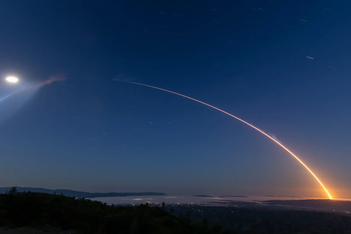SpaceX Starlink rocket launch streaking across the night sky