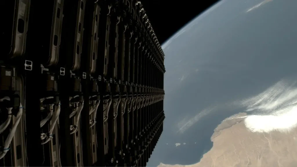 Close-up view of Starlink satellites stacked inside a SpaceX Falcon 9 rocket with Earth visible in the background.