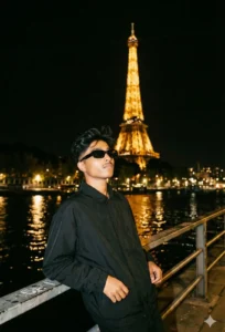 Google Gemini Cinematic Night Travel Portrait AI Photo Prompt showing a stylish man posing near the Eiffel Tower at night with cinematic city lights and realistic travel vibes