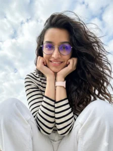 Low Angle Portrait AI Photo Editing Prompt for Girls showing a confident girl smiling, shot from below eye level with a natural sky background