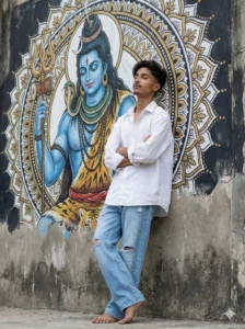 Young man posing in front of a Lord Shiva mural for Maha Shivratri AI photo editing prompt
