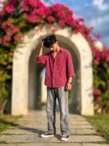 Young man posing in red striped shirt under floral archway with cinematic background blur ChatGPT Prompts Going Viral on Instagram