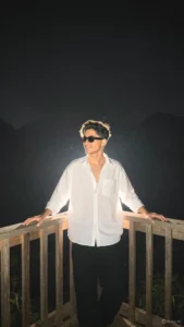 Cinematic night edit AI prompt result — boy standing on wooden railing with glowing backlight and dark moody background